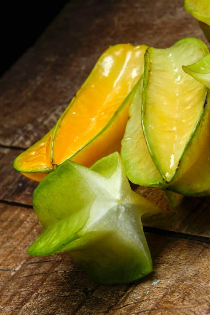 Whole and sliced star fruit showing its five-pointed shape